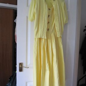 Sleeveless yellow dress with short sleeved cardigan