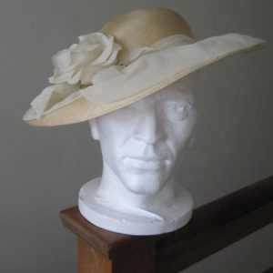 Cream hat with rose and ribbon detail