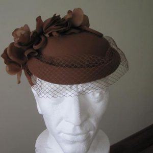 Tan hat with petal detail and netting