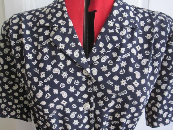 Navy patterned dress, short sleeved, buckle belt, pleated skirt